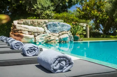 a row of towels sitting next to a swimming pool at Vila Santa Eulália in Albufeira