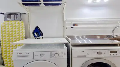 a kitchen with a washing machine and a sink at Vila Castro-Cleverdetails, Quiet area, private pool in Vilamoura