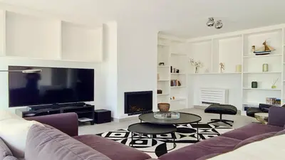 a living room with a couch and a tv at Vila Castro-Cleverdetails, Quiet area, private pool in Vilamoura