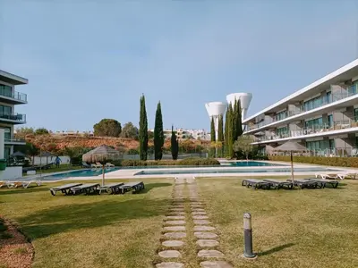 a row of benches in a park next to a building at RESIDENCE GOLF CLUB 415 in Quarteira