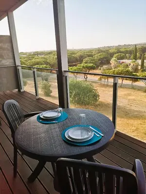 a table on a balcony with a view of a field at RESIDENCE GOLF CLUB 415 in Quarteira