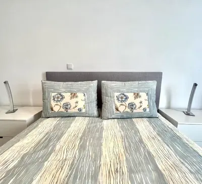 a bedroom with a bed with two pillows on it at Beachside Apartment - With Pool by HD PROPERTIES in Quarteira