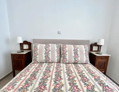 a bedroom with a bed with two night stands at Beachside Apartment - With Pool by HD PROPERTIES in Quarteira