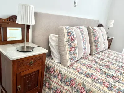 a bedroom with a bed with a lamp on a night stand at Beachside Apartment - With Pool by HD PROPERTIES in Quarteira