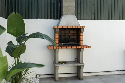 a bird house sitting on a stand next to a wall at NUZZA - Vilamoura Marina with BBQ in Vilamoura