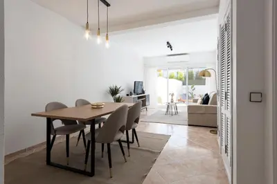 a dining room and living room with a table and chairs at NUZZA - Vilamoura Marina with BBQ in Vilamoura