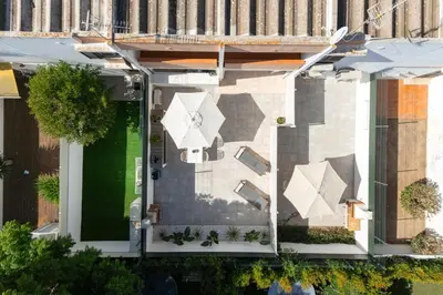 an overhead view of a patio with white umbrellas at NUZZA - Vilamoura Marina with BBQ in Vilamoura
