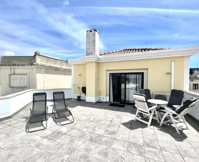 a patio with chairs and a table on a roof at Nancy Apartment - Near Vilamoura Marina by HD PROP in Vilamoura