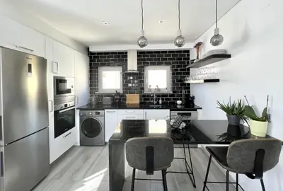 a kitchen with a table and chairs in a room at Nancy Apartment - Near Vilamoura Marina by HD PROP in Vilamoura