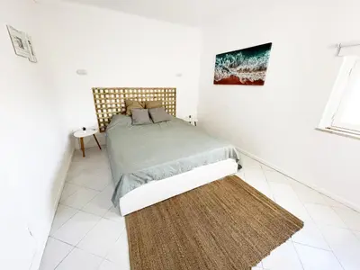 a bedroom with a bed and a rug at Panoramic Seaview - 2 Bedroom, Main Ave, 15 Min Walk Beach, Workspace in Albufeira