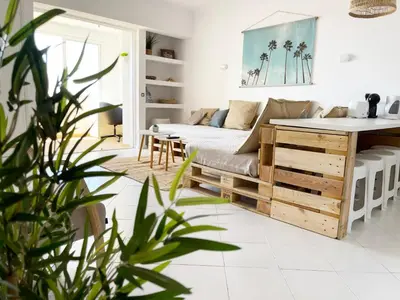 a living room with a couch and a table at Panoramic Seaview - 2 Bedroom, Main Ave, 15 Min Walk Beach, Workspace in Albufeira