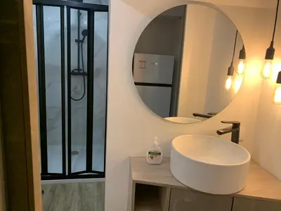 a bathroom with a white sink and a mirror at CASA DAS CEGONHAS in Faro