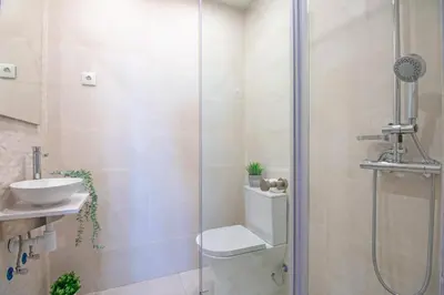 a bathroom with a shower with a toilet and a sink at Quinta Molinum Ad Mare in Boliqueime