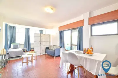 a balcony with a table and a view of a building at Amendoeiras by MTPhomes in Quarteira
