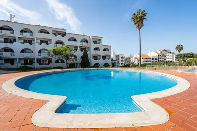 a large swimming pool in front of a building at Apartamento Centro de Albufeira Sunny in Albufeira