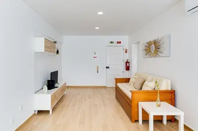 a living room with a couch and a table at T1 Albufeira city centre in Albufeira