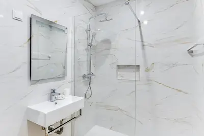 a white bathroom with a shower and a sink at T1 Albufeira city centre in Albufeira