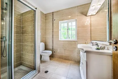 a bathroom with a shower and a toilet and a sink at Casa Palmeira in Terras Novas