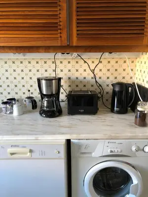 a kitchen counter with a appliance on top of a stove at FeWo Cesar Manrique - Albufeira, Portugal in Albufeira