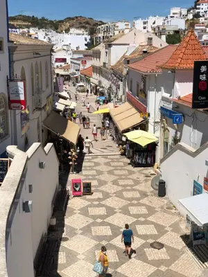 an overhead view of a town with people walking down a street at FeWo Cesar Manrique - Albufeira, Portugal in Albufeira