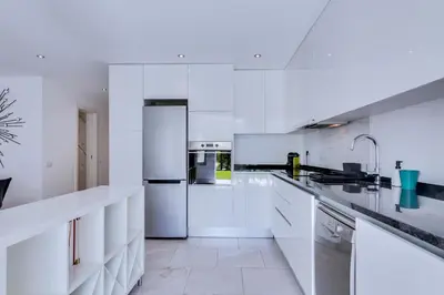 a white kitchen with white counters and appliances at AL - Barracuda Village in Vilamoura