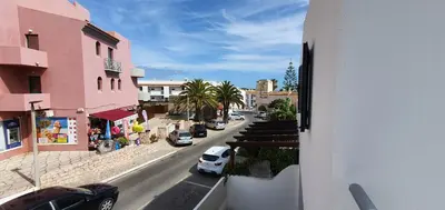 a view of a street with cars parked on the road at Beach View Vela House in Albufeira
