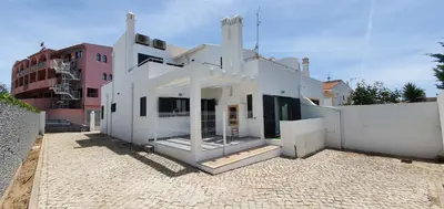 a white building sitting on a brick road at Beach View Vela House in Albufeira