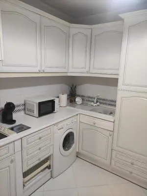 a white kitchen with a microwave and a dishwasher at Vilamoura Marina, Av Tivoli in Vilamoura