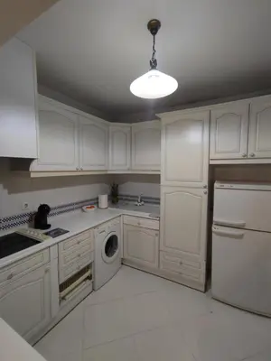 a white kitchen with white cabinets and a dishwasher at Vilamoura Marina, Av Tivoli in Vilamoura
