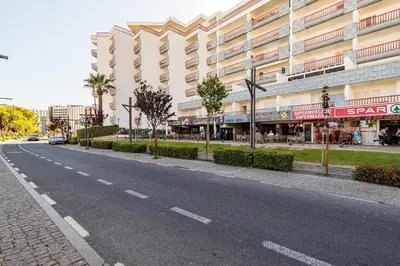 an empty street in front of a large building at Vilamoura Marina, Av Tivoli in Vilamoura
