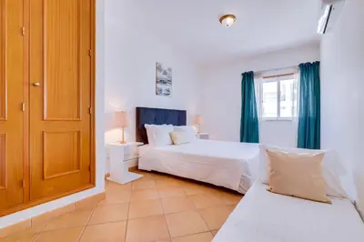 a bedroom with two beds and a window at AL - Colina Beach Holidays in Quarteira