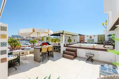 an outdoor patio with a bar and a table at Marina Real - Sea View by HD PROPERTIES in Vilamoura
