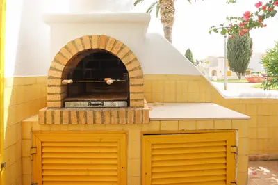 an outdoor pizza oven on a patio at Villa Aldeia do Golf - BY BEDZY in Vilamoura