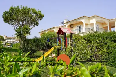 a playground in the yard of a house at #093 Vista das Ondas by Home Holidays in Albufeira