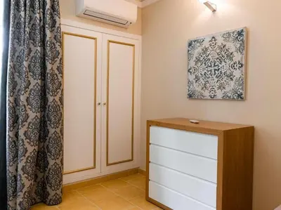 a room with a closet and a dresser and a curtain at Albufeira Sol Villas I by Stay ici Algarve Holiday Rental in Albufeira