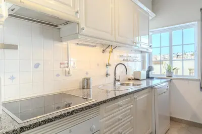 a dining room with a table and a window at #056 Old Post Office by Home Holidays in Albufeira