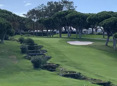 a golf course with trees and a green field at Large apartment in Vale do Lobo in Almancil