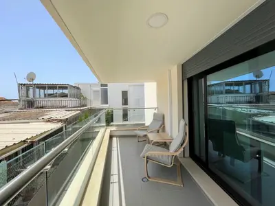 a balcony with two chairs and a large window at Faro Design 1 by Homing in Faro