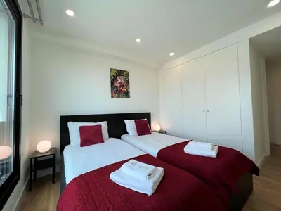 a bedroom with a large bed with towels on it at Faro Design 3 by Homing in Faro
