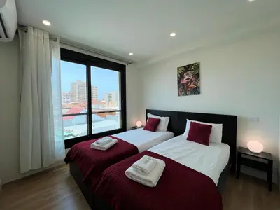 two beds in a room with a large window at Faro Design 3 by Homing in Faro