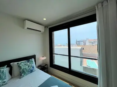 a bedroom with a large window with a view at Faro Design 2 by Homing in Faro