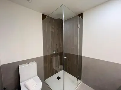 a bathroom with a toilet and a glass shower at Faro Design 2 by Homing in Faro
