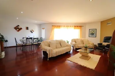 a living room with two chairs and a table at 3-Bed Townhouse with pool in Albufeira Balaia in Albufeira