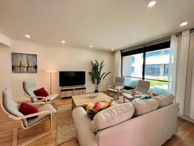a living room with a couch and chairs and a television at Faro Design 6 by Homing in Faro