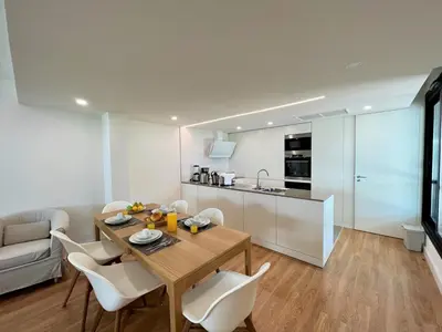a kitchen and dining room with a table and chairs at Faro Design 6 by Homing in Faro