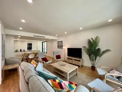 a living room with a couch and a table at Faro Design 6 by Homing in Faro
