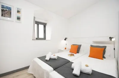 a bedroom with two beds with red and blue pillows at In Downtown - Villa Serenity in Albufeira
