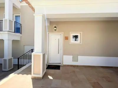 an empty hallway with a white door and stairs at Albufeira Deluxe Residence With Pool by Homing in Albufeira