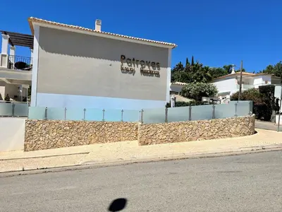 a building with a sign on the side of a street at Albufeira Deluxe Residence With Pool by Homing in Albufeira