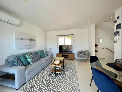 a living room with a couch and a table at Albufeira Deluxe Residence With Pool by Homing in Albufeira